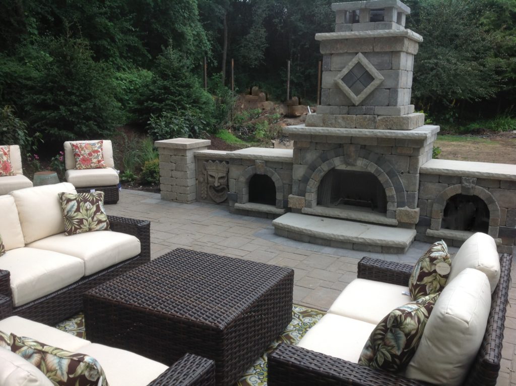 OUTDOOR LANDSCAPE WITH FIREPLACE AND UNIQUE STATUE STONES
