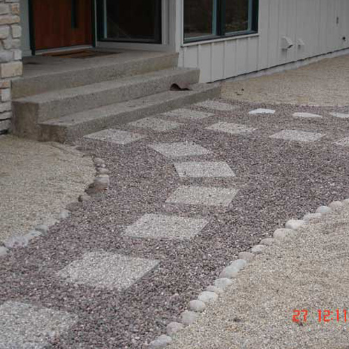 walkway to a paver patio in the backyard