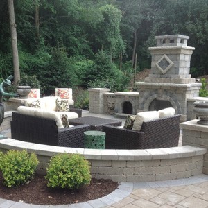indoor brought to outdoor patio with fireplace and seating arrangments