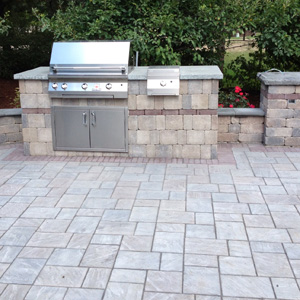 OUTDOOR kitchen GRILL BUILT INTO UNILOCK STONE