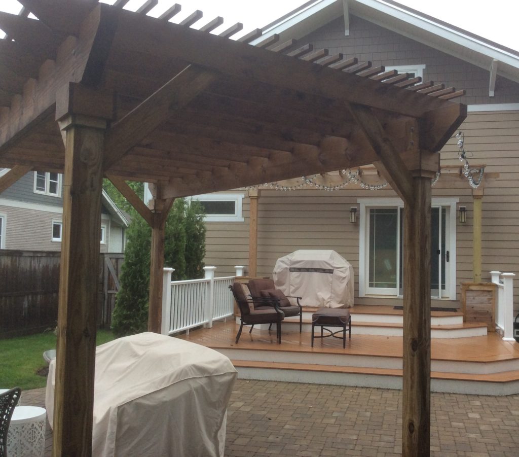 BROWN PERGOLA COVERING UNILOCK PAVER PATIO