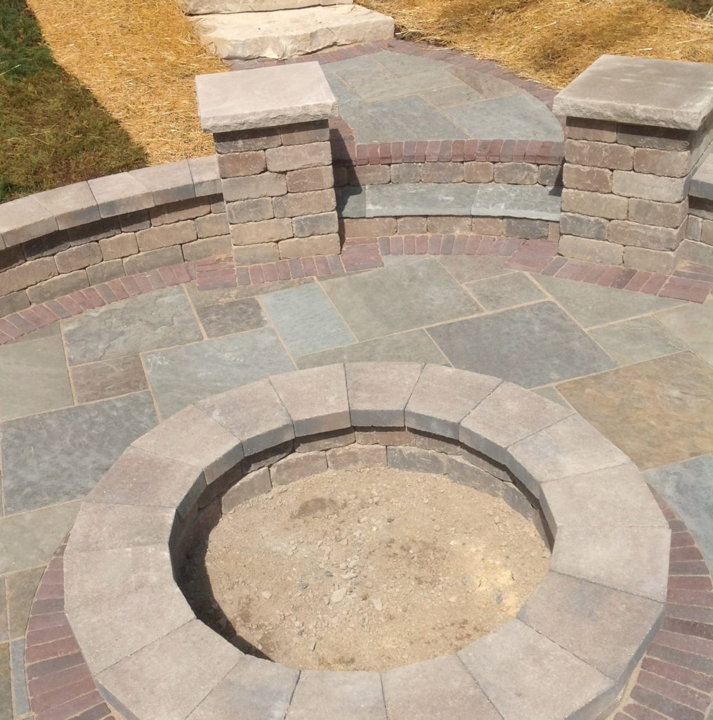 UNILOCK FIRE PIT WITH SEAT WALL, PILLARS AND WALKWAY WITH STEPS