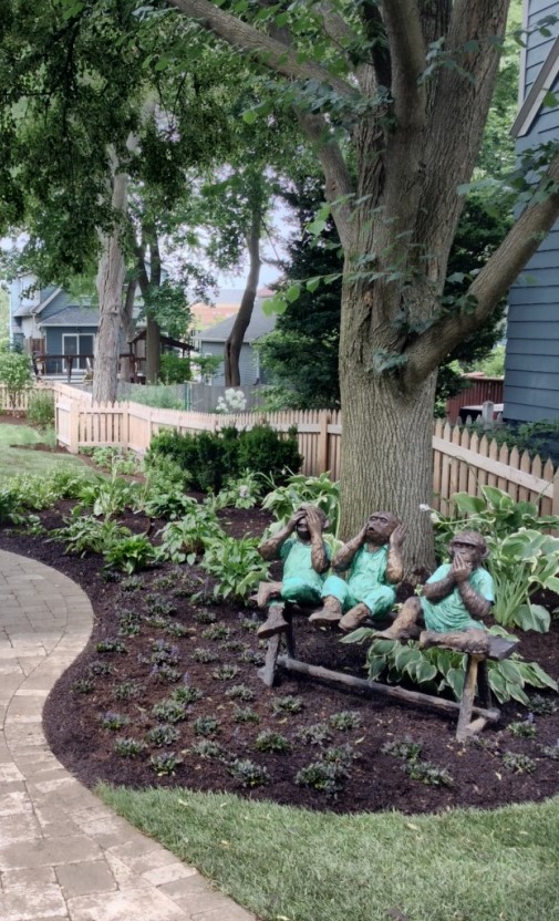 THREE MONKEYS ON A BENCH IN OUTDOOR GARDEN DESIGN IN BARRINGTON, ILLINOIS