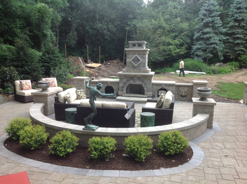 OUTDOOR LANDSCAPE WITH OUTDOOR SEATING IN FRONT OF FIRE PLACE