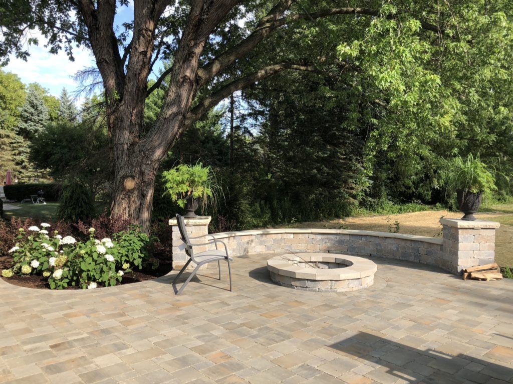 UNILOCK BRUSSEL STONE WITH FIRE PIT AND HALF MOON SEAT WALL