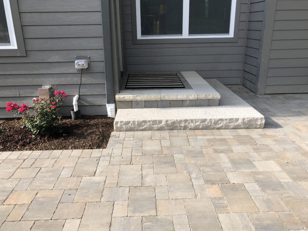 STEPS FROM THE BACK DOOR LEADING INTO uNILOCK PAVER PATIO