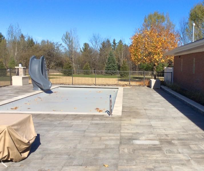 POOL WITH SLIDE AFTER INSTALLATION OF UNILOCK PAVER
