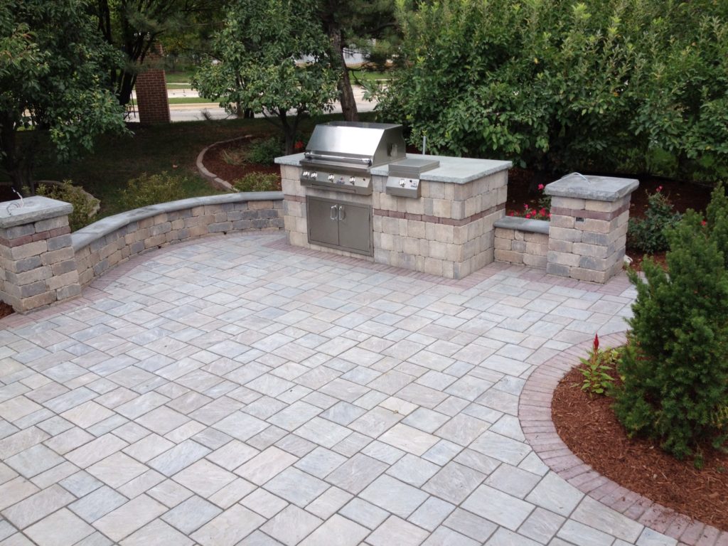 Paver patio with outdoor grill built into unilock stone