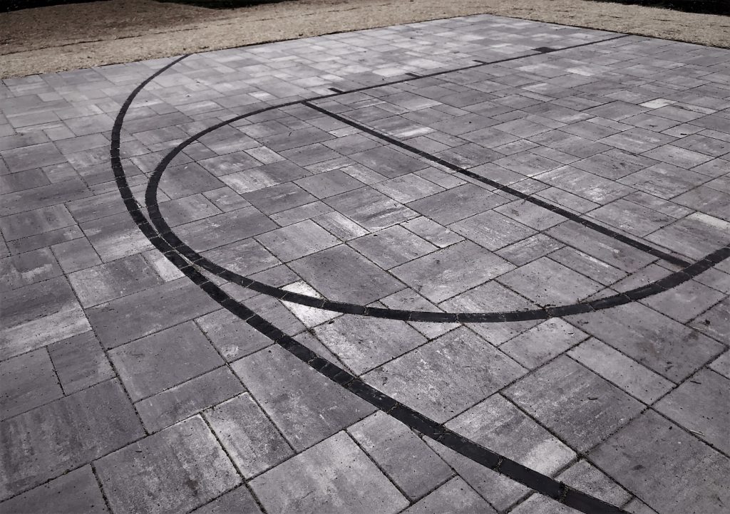 OUTDOOR BASKETBALL COURT BUILT WITH UNILOCK STONE